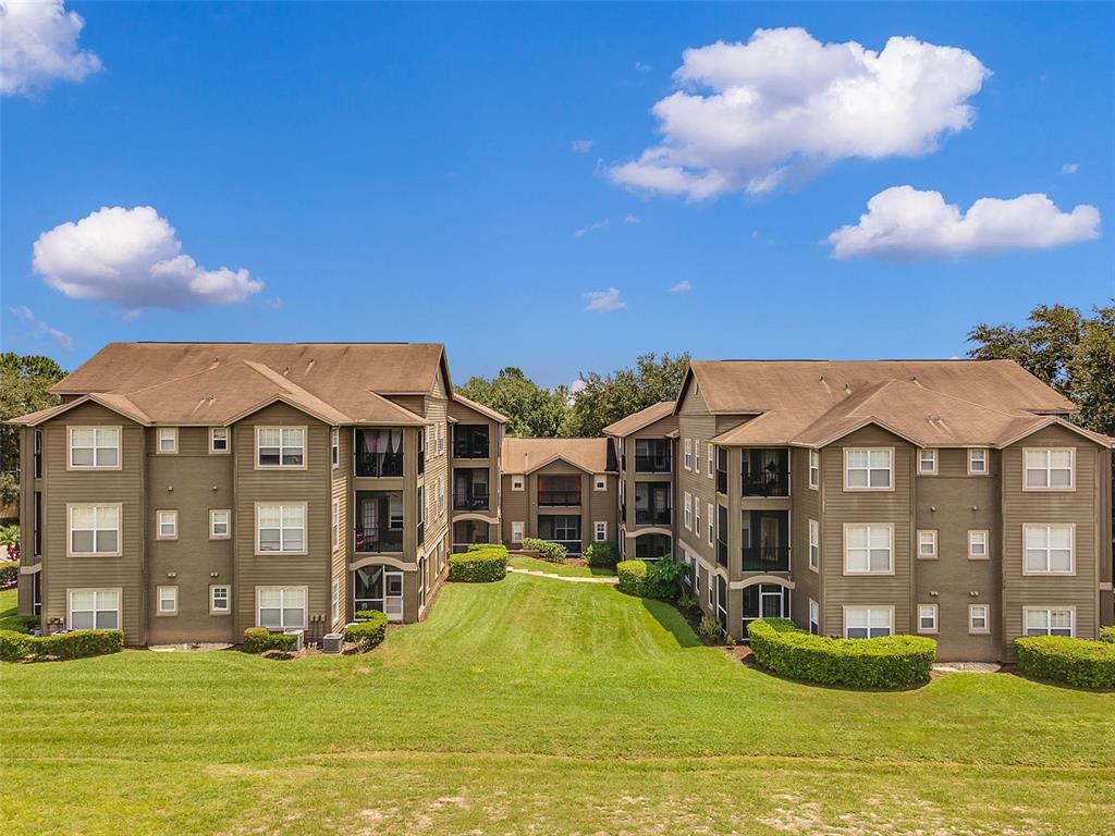 408 Summit Ridge Place, Unit 210 Longwood, FL 32779 - Photo 3 of 32 a view of a house with swimming pool and a yard