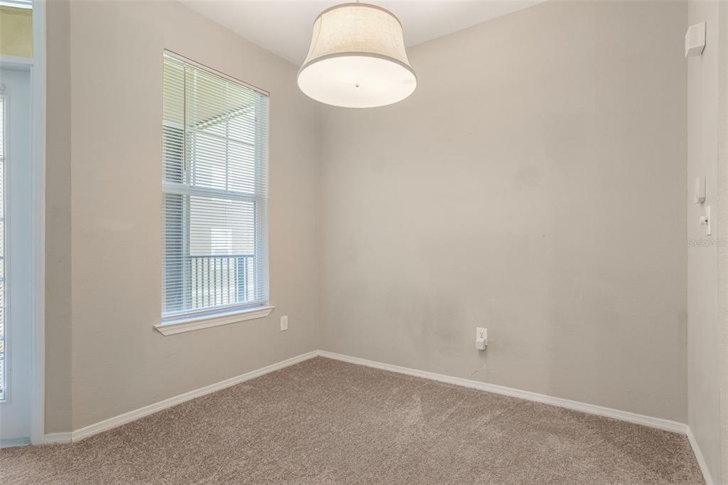 408 Summit Ridge Place, Unit 210 Longwood, FL 32779 - Photo 6 of 32 an empty room with windows and cabinet
