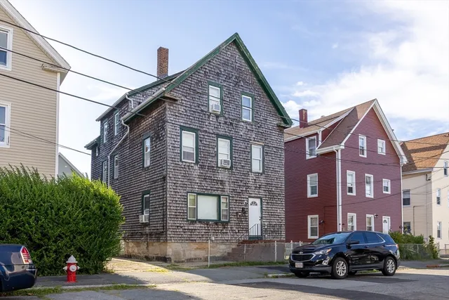 a car parked in front of a brick house