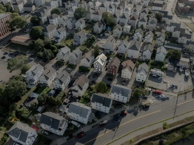 an aerial view of residential houses with outdoor space