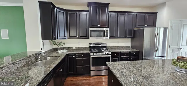 a kitchen with a stove a sink and a refrigerator
