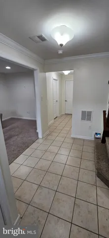 a view of a livingroom with a couch and chandelier