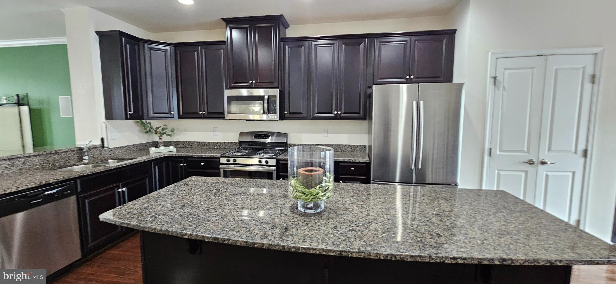 420 Lopata Road Phoenixville, PA 19460 - Photo 21 of 38 a kitchen with kitchen island a sink refrigerator and microwave