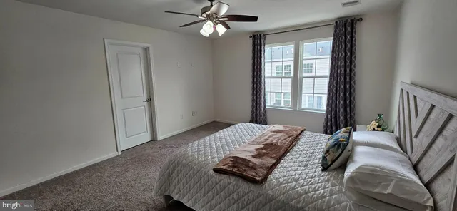 a bedroom with a large bed and a window
