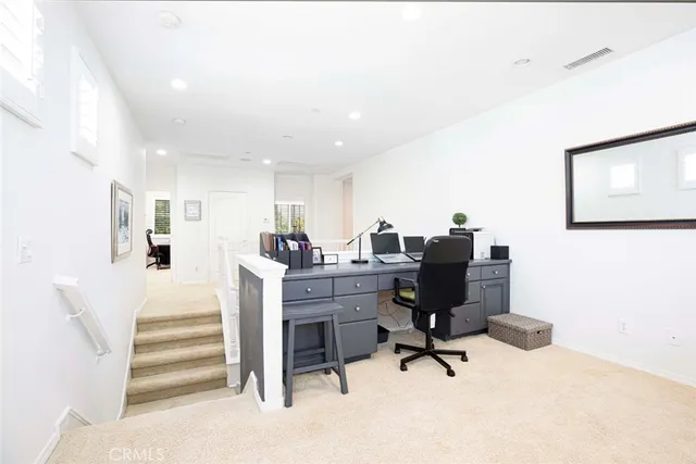 a bedroom with a bed and a large mirror