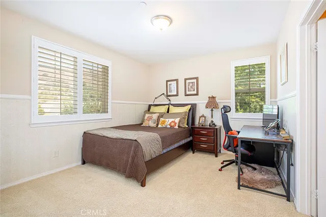 a view of backyard with swimming pool and seating space