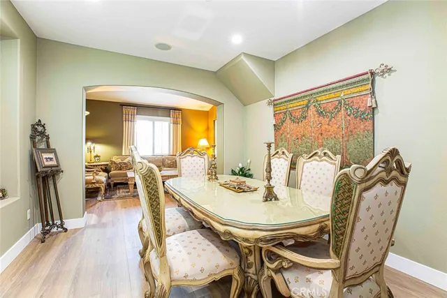 a kitchen with stainless steel appliances granite countertop a table chairs stove and refrigerator