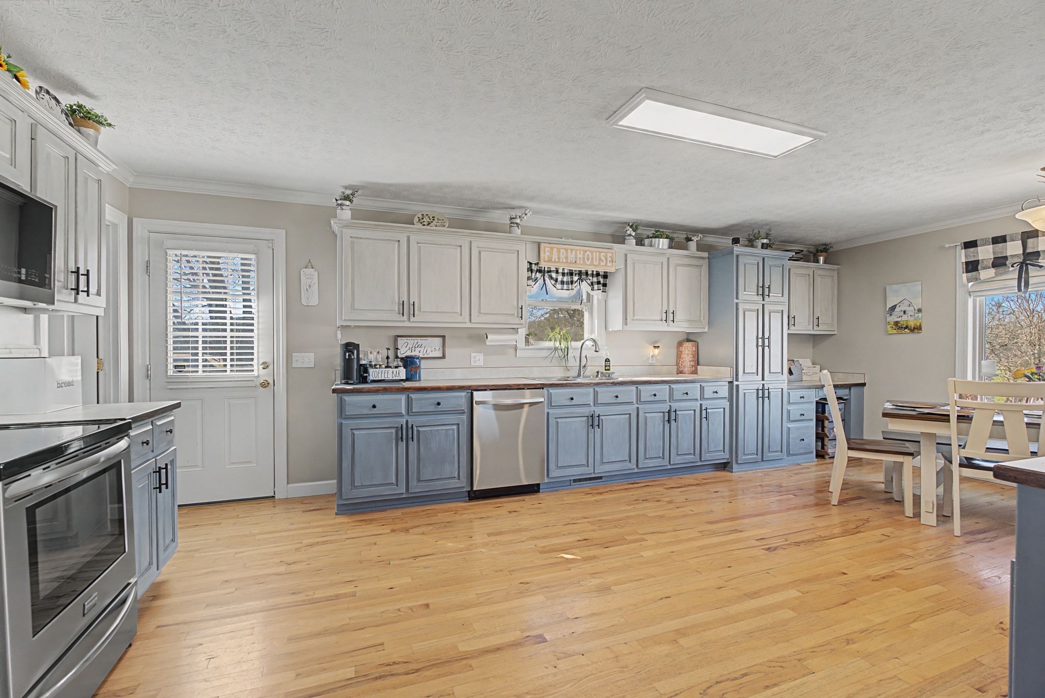 48 Fox Run Lane Carthage, TN 37030 - Photo 18 of 38 a kitchen with stainless steel appliances granite countertop a stove top oven a sink dishwasher and white cabinets with wooden floor