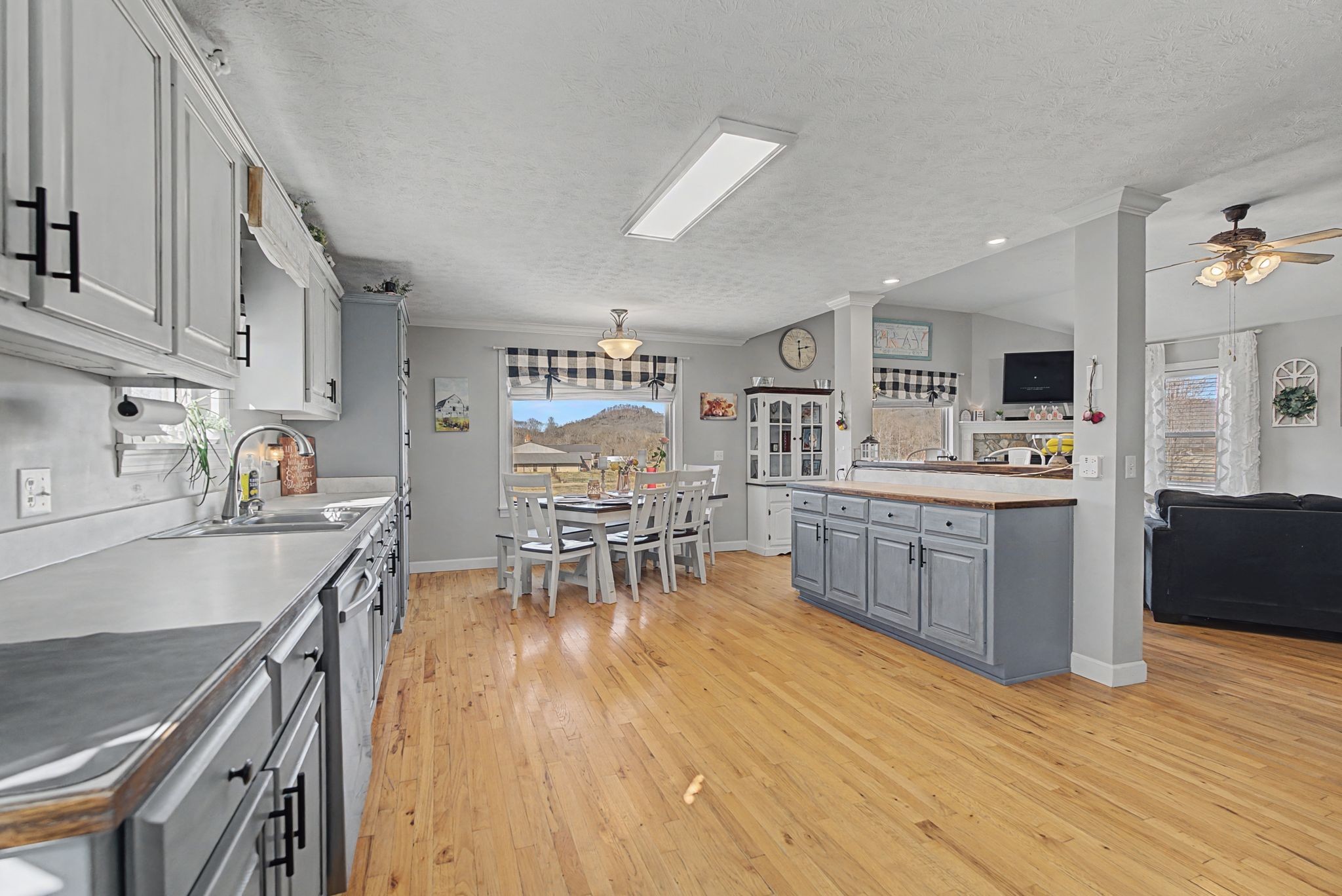 48 Fox Run Lane Carthage, TN 37030 - Photo 21 of 38 a kitchen with stainless steel appliances wooden floors and wooden cabinets