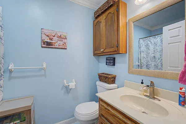 a bathroom with a sink a toilet and mirror