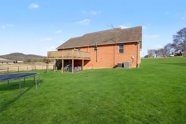 an outdoor view of a house with a backyard
