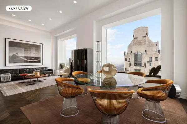 a living room with furniture a rug and a chandelier