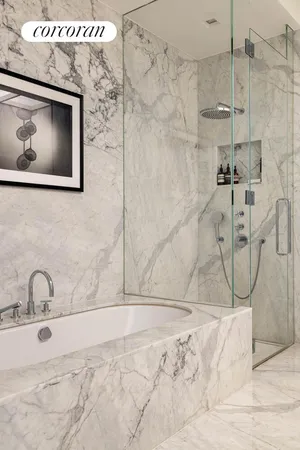 a bathroom with a tub sink and mirror
