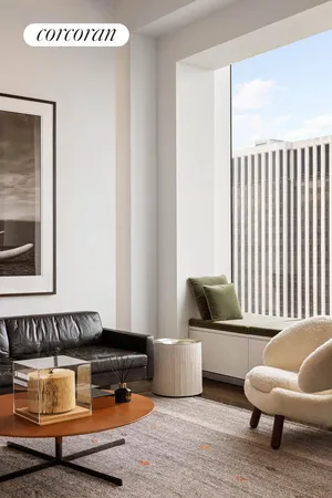 a living room with furniture and floor to ceiling window