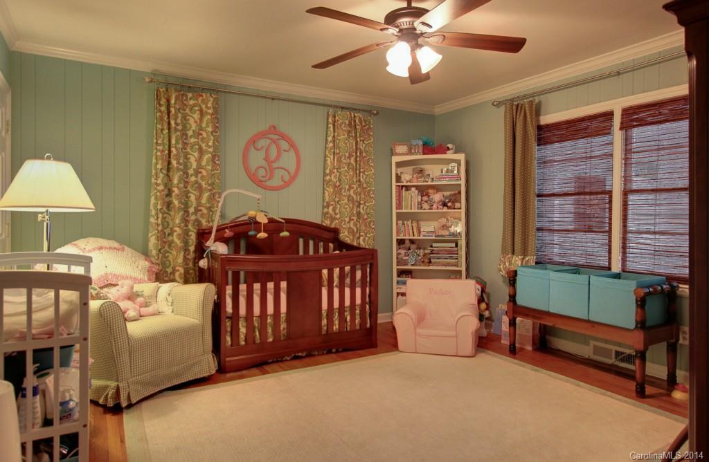 4310 Walker Road Charlotte, NC 28211 - Photo 13 of 16 a bedroom with a bed and a chandelier