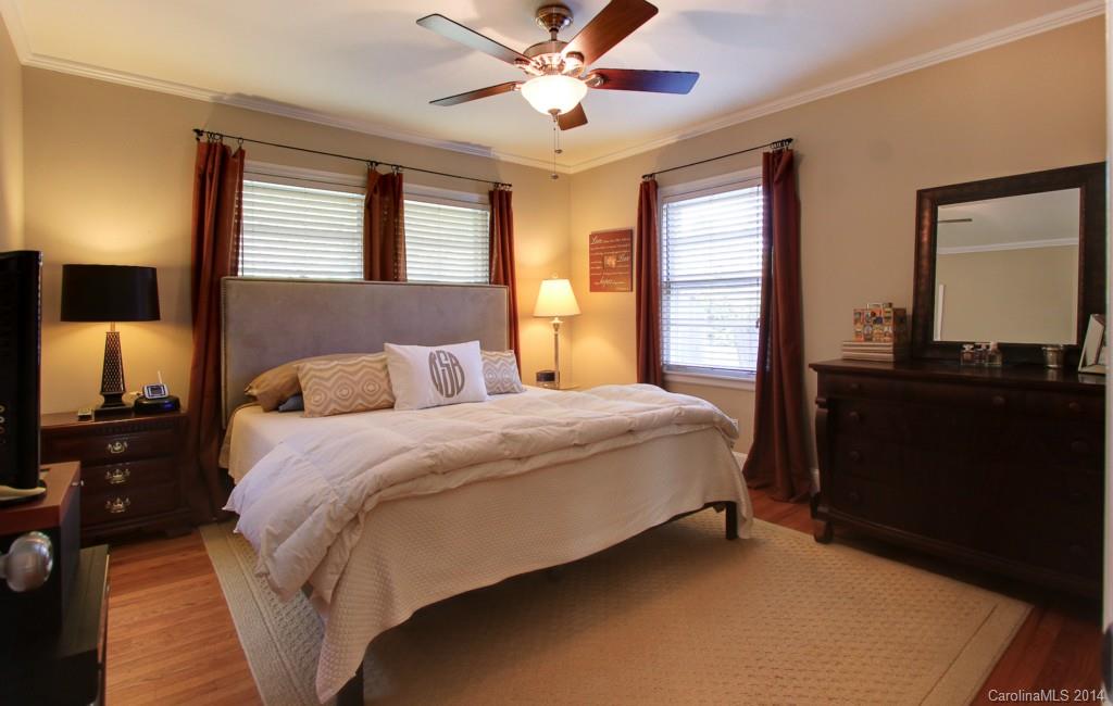 4310 Walker Road Charlotte, NC 28211 - Photo 9 of 16 a bedroom with a bed and a chandelier