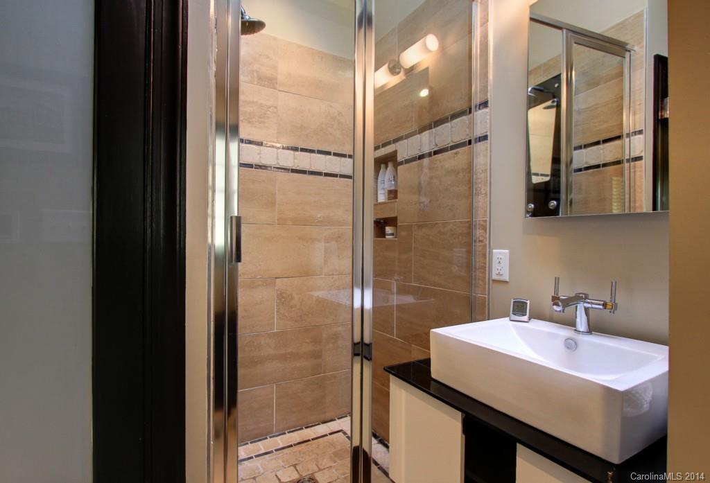 4310 Walker Road Charlotte, NC 28211 - Photo 10 of 16 a bathroom with a sink shower and a mirror