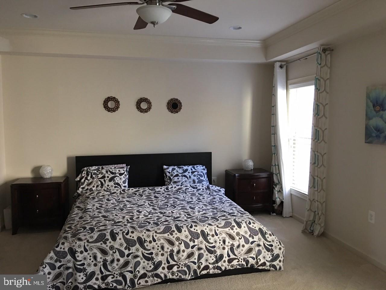 23337 Tradewind Drive Ashburn, VA 20148 - Photo 18 of 28 a large bed in a bedroom next to a window