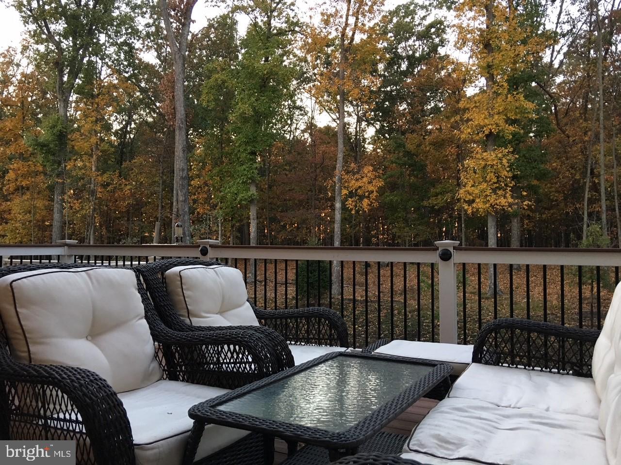 23337 Tradewind Drive Ashburn, VA 20148 - Photo 27 of 28 a roof deck with couches and wooden fence