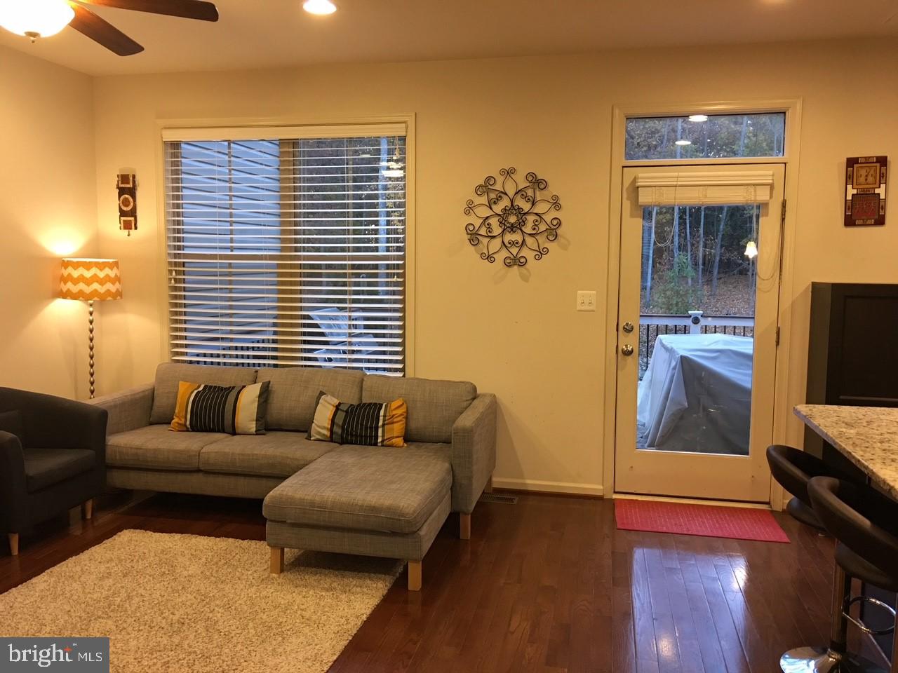 23337 Tradewind Drive Ashburn, VA 20148 - Photo 7 of 28 a living room with furniture and a flat screen tv
