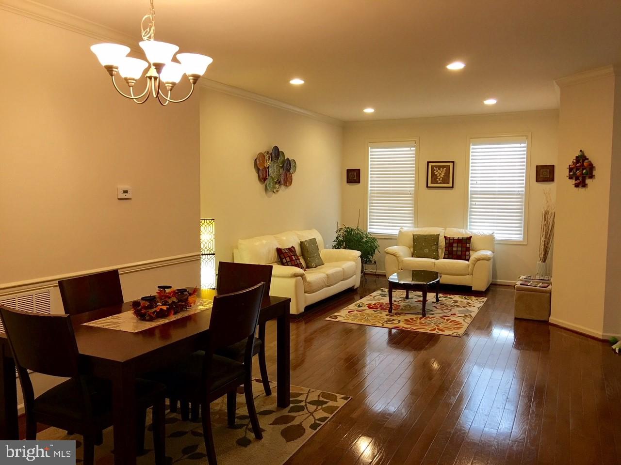 23337 Tradewind Drive Ashburn, VA 20148 - Photo 8 of 28 a living room with furniture dining table and a chandelier