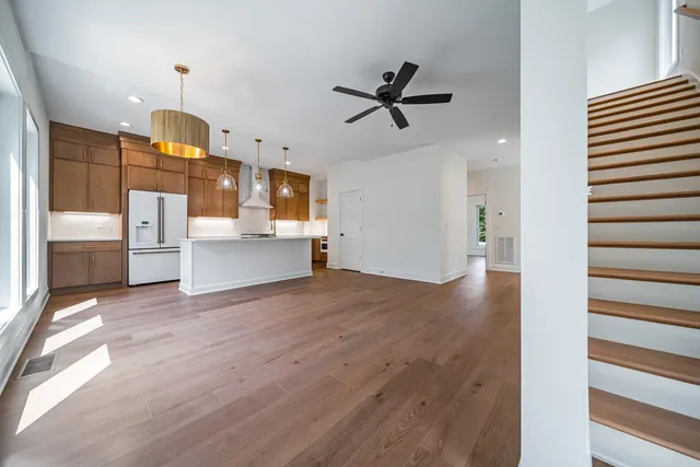 a view of a kitchen with a sink cabinet a kitchen and dishwasher with wooden floor