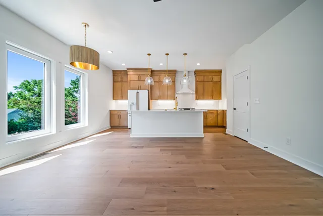 a view of an empty room with window and cabinet
