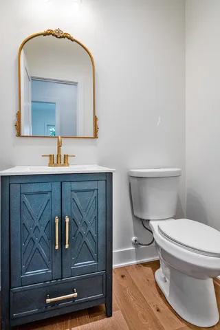 a bathroom with a toilet a sink and mirror