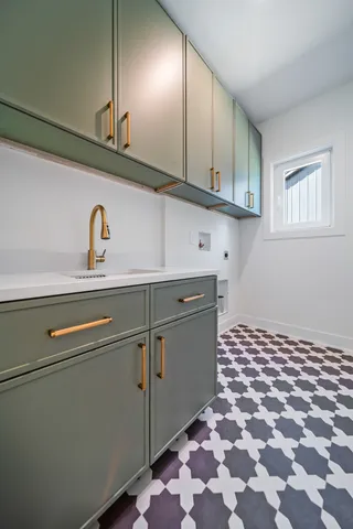 a close view of a sink a counter space and cabinets