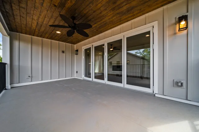 a view of a livingroom with wooden floor and a ceiling fan