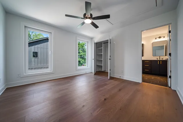 a bathroom with a double vanity sink toilet mirror and bathtub