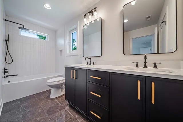a bathroom with a double vanity sink and a mirror