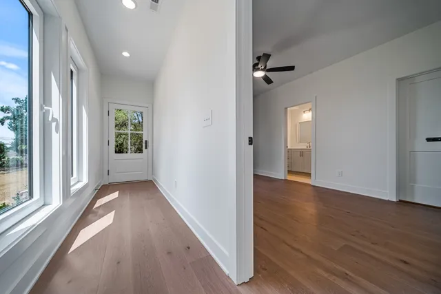 wooden floor in an empty room with a window
