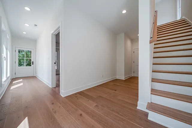 a view of wooden floor and windows in a room