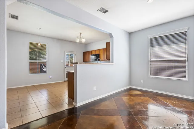 a kitchen with granite countertop stainless steel appliances cabinets a sink and a window