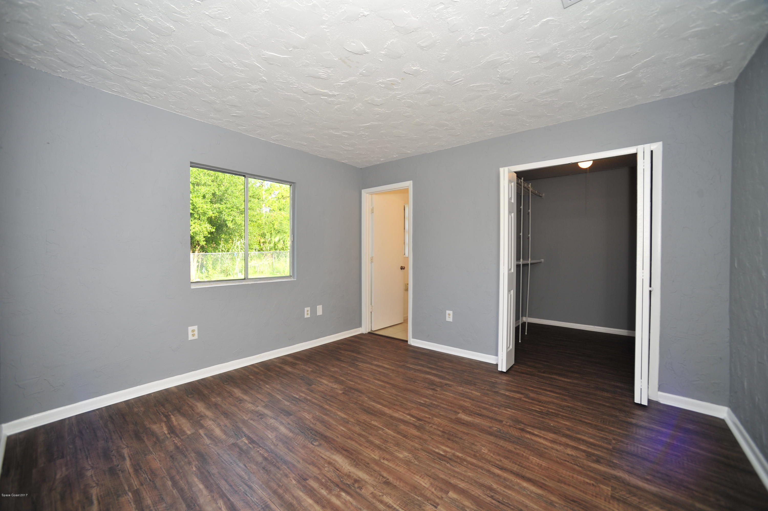 875 Doverbrook Road Northwest Palm Bay, FL 32907 - Photo 12 of 17 master bedroom w walk-in closet