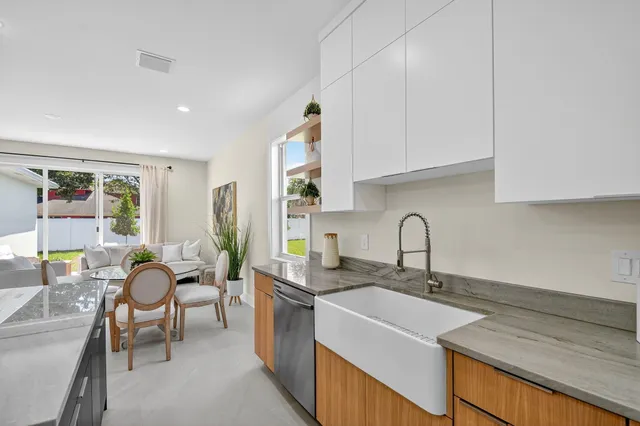 a living room with furniture and kitchen view