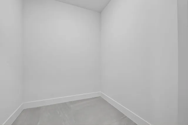 a bedroom with a bed and a night stand