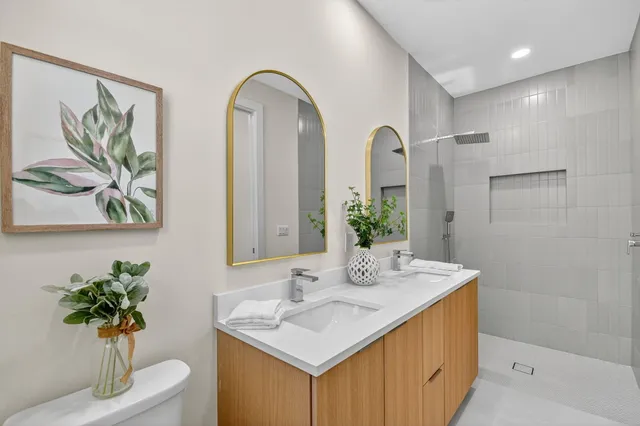 an aerial view of residential houses with outdoor space and trees