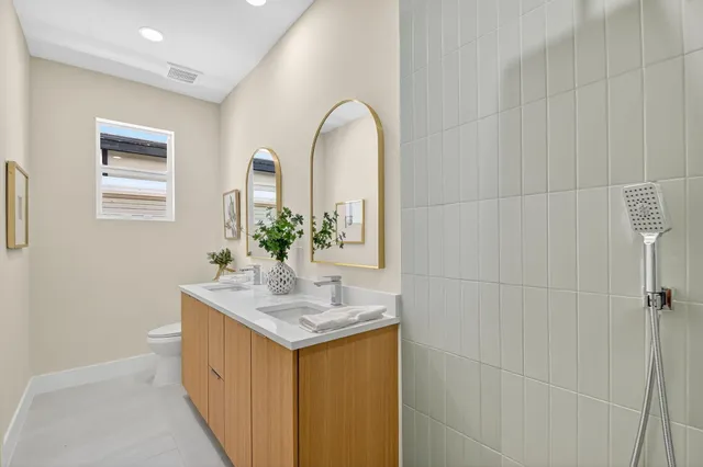 an aerial view of a tennis ground and a cars park side of the road