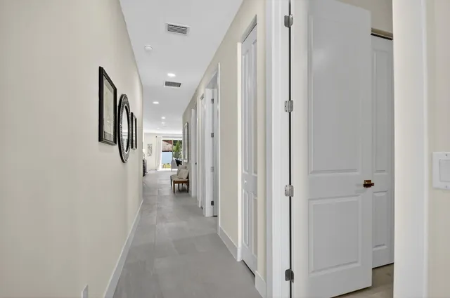 a kitchen with stainless steel appliances granite countertop sink stove and white cabinets with wooden floor