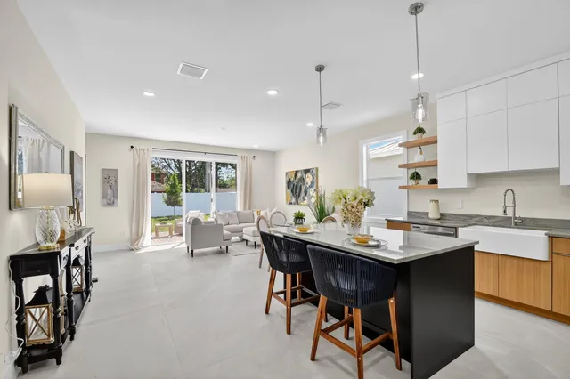 a kitchen with stainless steel appliances a stove a refrigerator a sink and cabinets