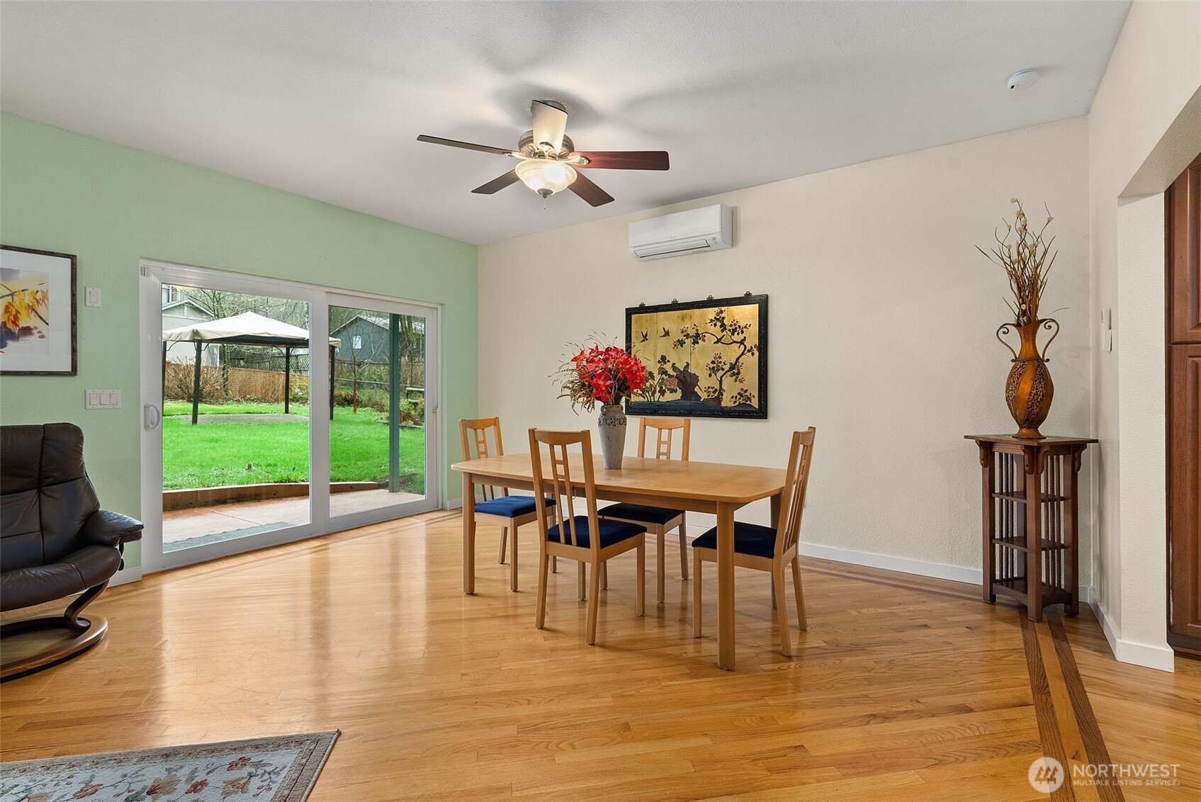1105 Irving Street Southwest Tumwater, WA 98512 - Photo 13 of 38 a dining room with wooden floor a chandelier a glass table and chairs