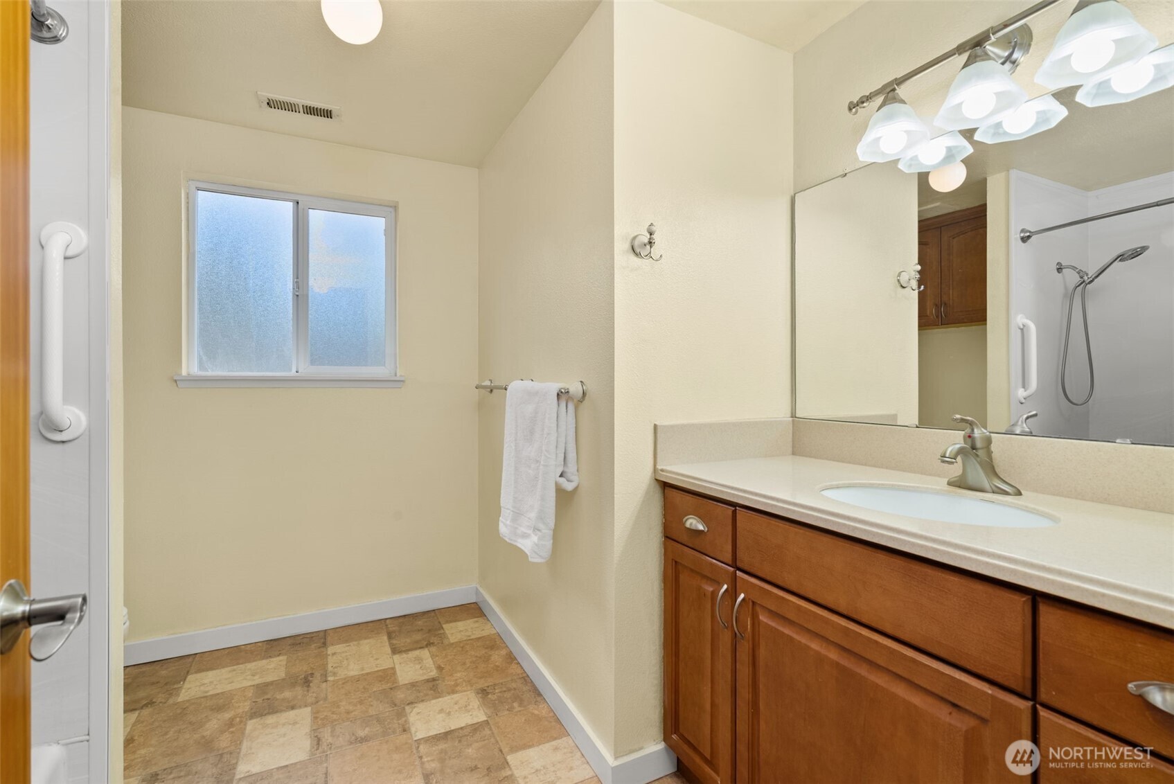 1105 Irving Street Southwest Tumwater, WA 98512 - Photo 17 of 38 a bathroom with a granite countertop sink a large mirror and a shower