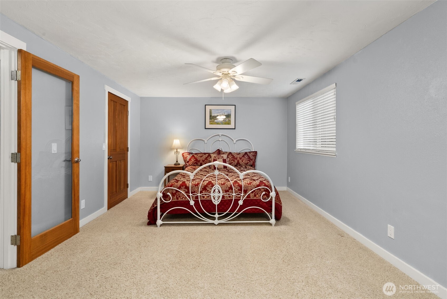 1105 Irving Street Southwest Tumwater, WA 98512 - Photo 20 of 38 a bedroom with a bed and a chandelier