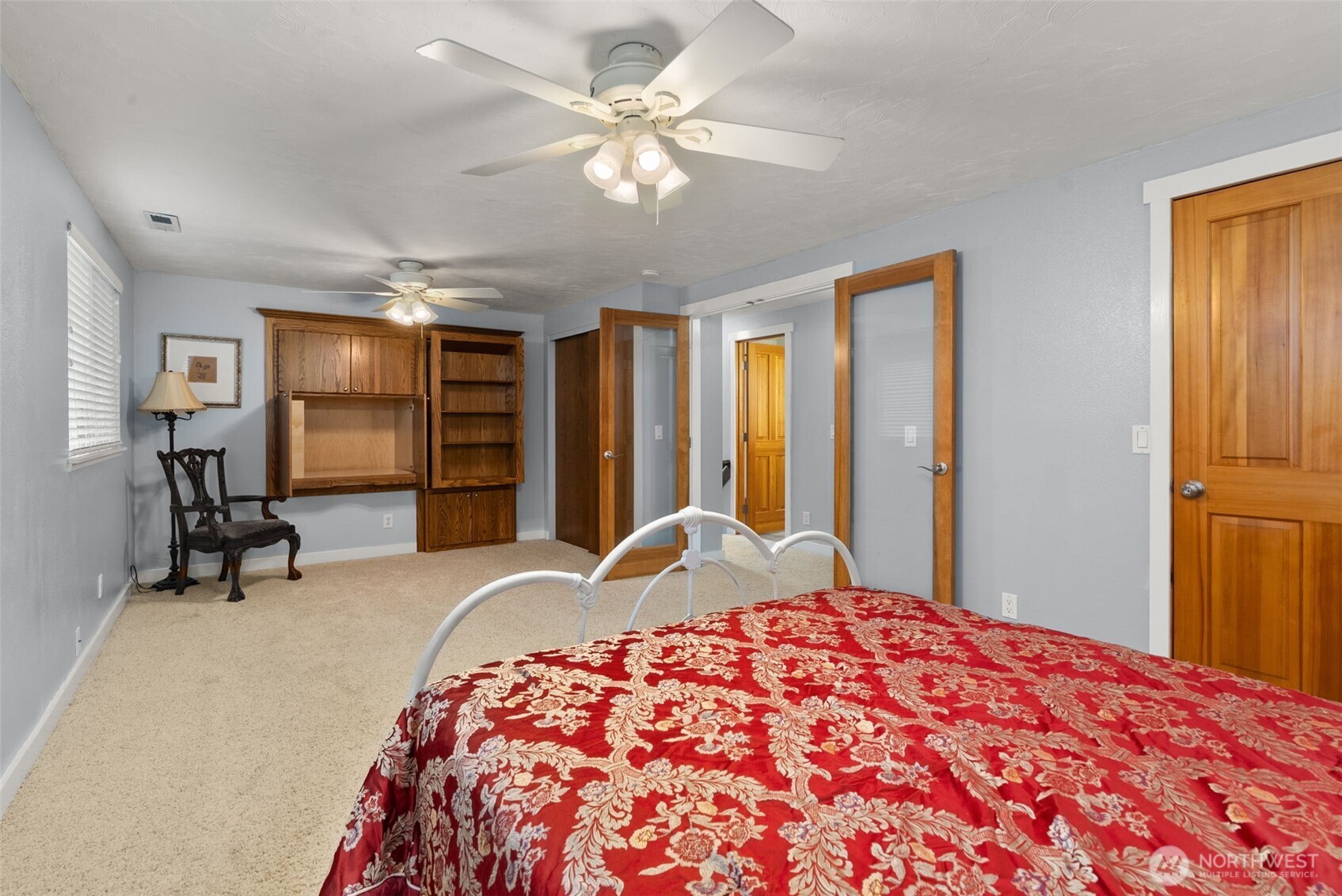 1105 Irving Street Southwest Tumwater, WA 98512 - Photo 21 of 38 a bedroom with a large bed and a chandelier