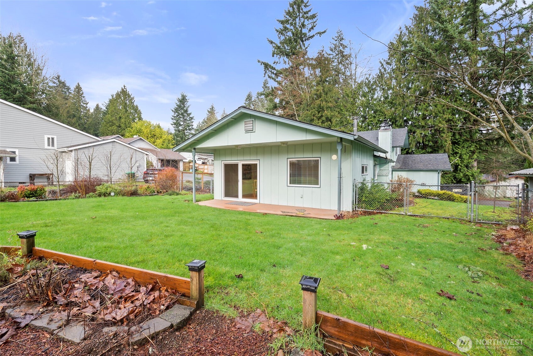1105 Irving Street Southwest Tumwater, WA 98512 - Photo 35 of 38 a front view of a house with a yard and trees