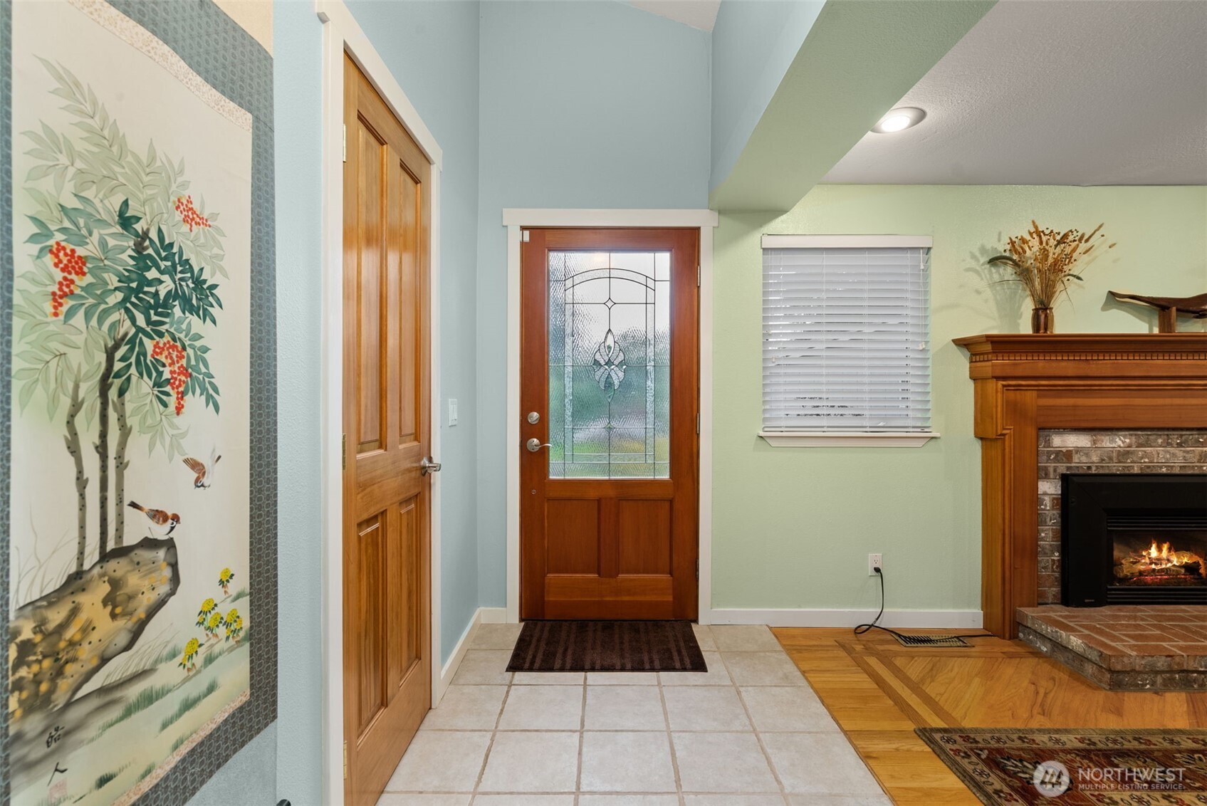 1105 Irving Street Southwest Tumwater, WA 98512 - Photo 4 of 38 a hallway with a fireplace and a potted plant