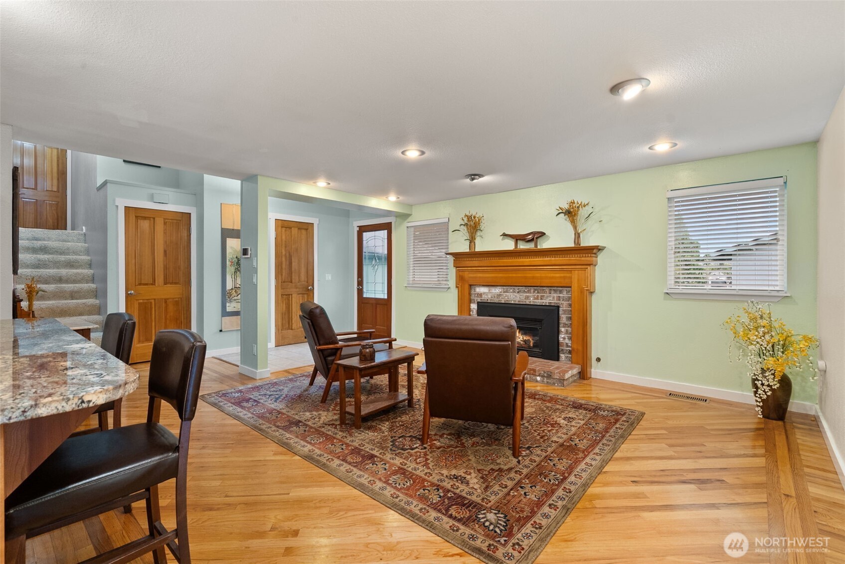 1105 Irving Street Southwest Tumwater, WA 98512 - Photo 6 of 38 a living room with furniture a dining table and a fireplace