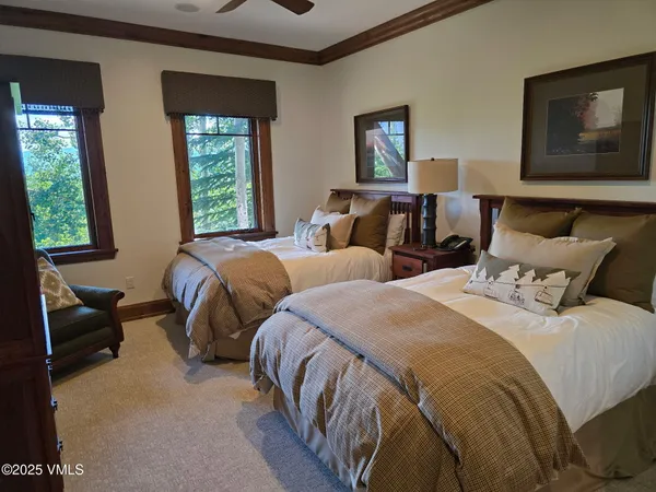a bedroom with two beds and a window